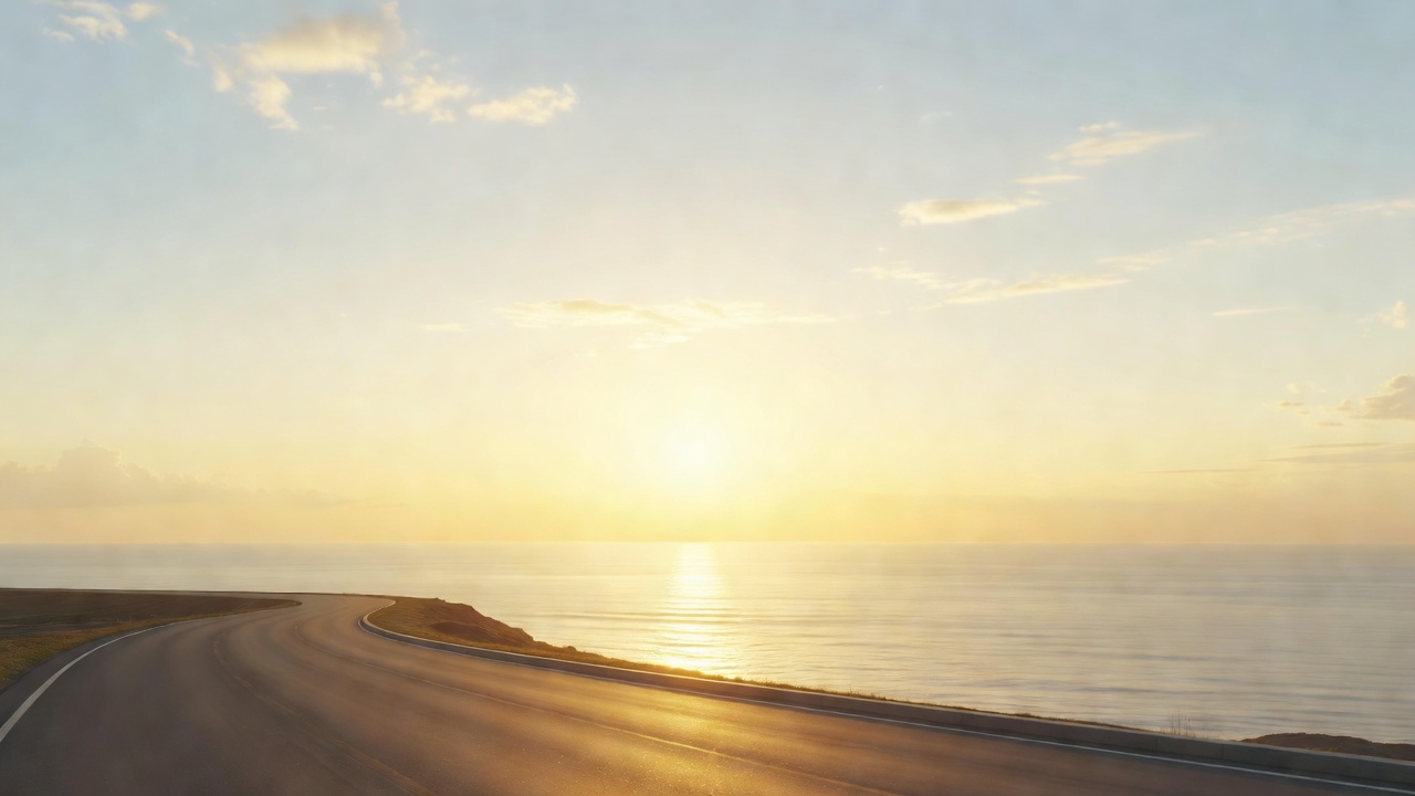 A wide bright sunrise over an open road curving toward a luminous horizon